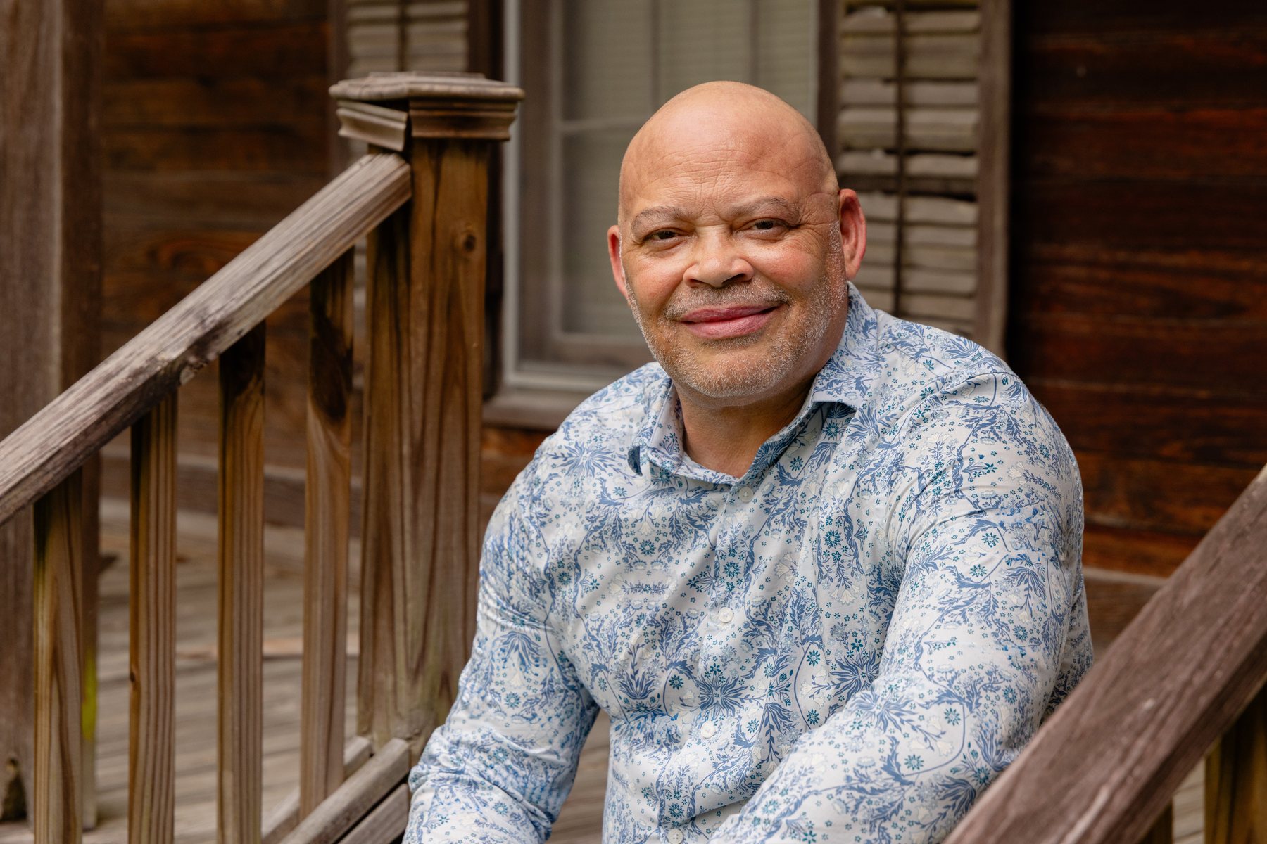 Milton Arceneaux on the porch of a historic home in Grand Coteau